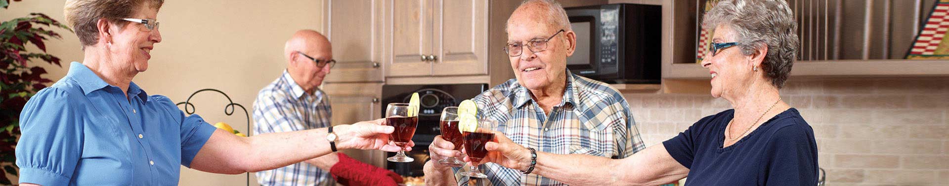 Seasons residents sayings cheers to a drink in the kitchen
