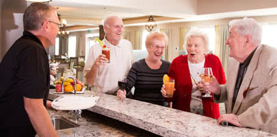Seasons reisdents gathering and smiling while enjoying a drink